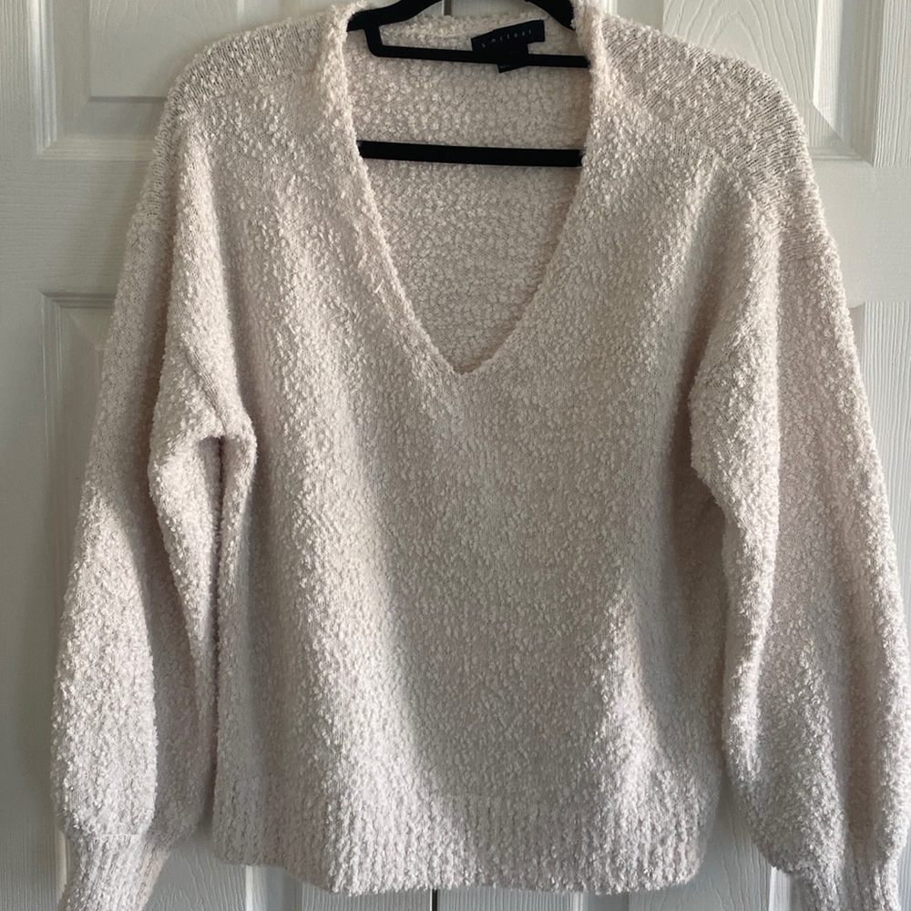 Off-white color revolve sweater.